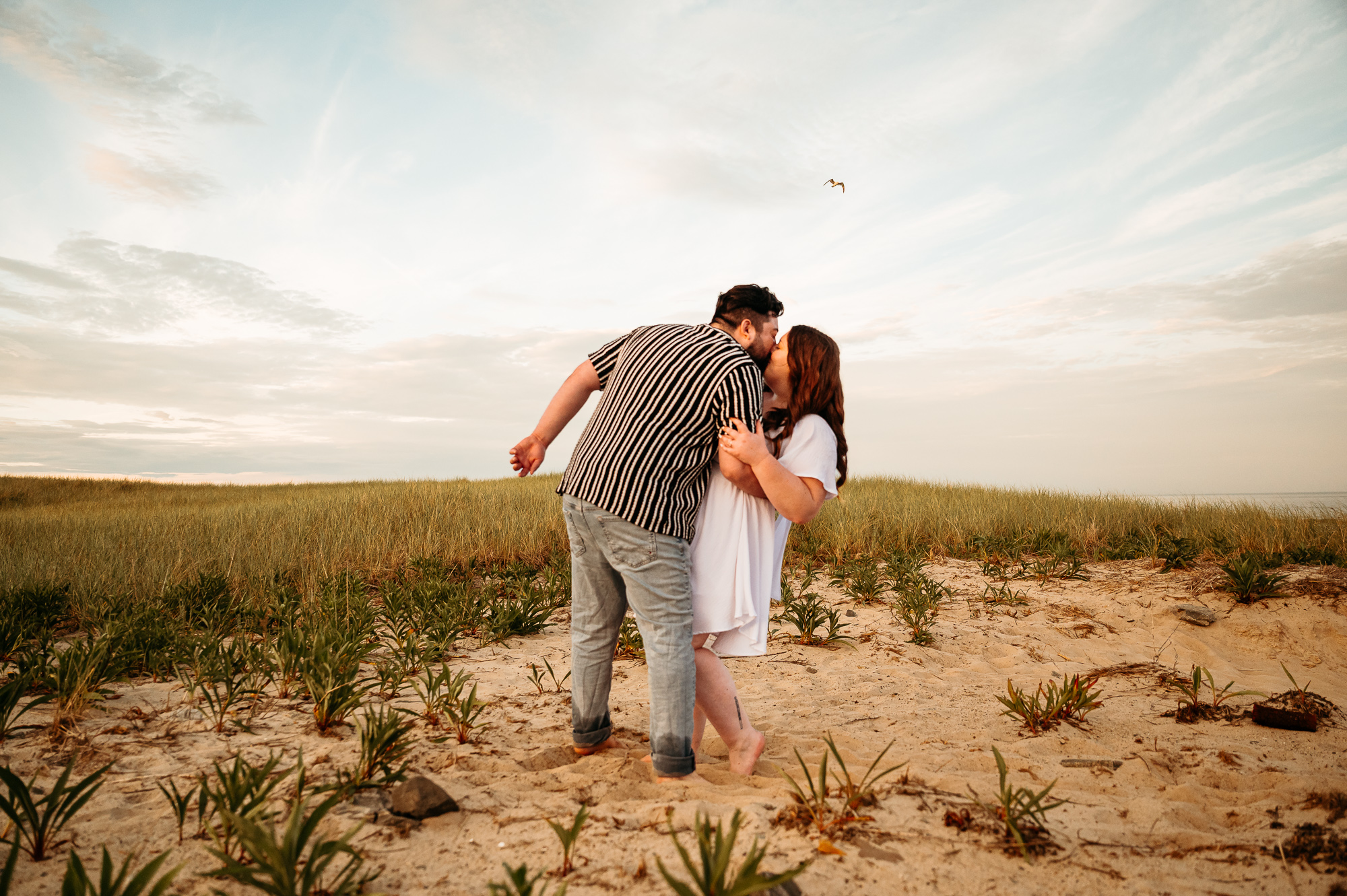 Hampton Beach engagement portraits with golden hour glow on the seacoast of New Hampshire